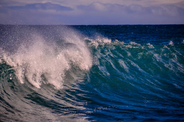 The ocean is blue and the waves are crashing