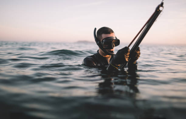 istock Spearfisherman prepare speargun for fish hunting 2151701226