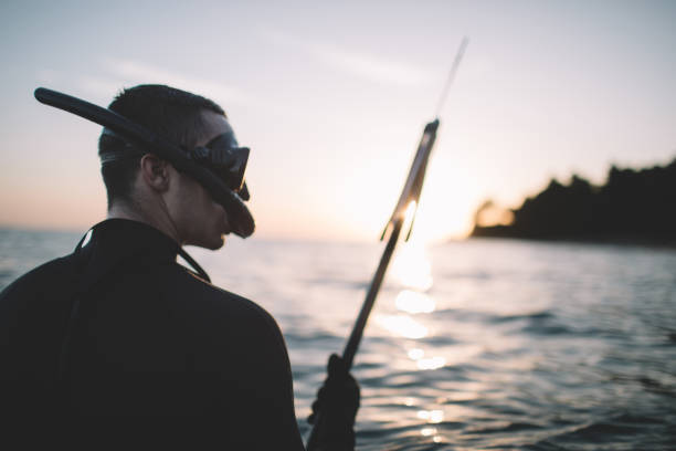istock Side view of spearfisherman holding spear gun 2151701234