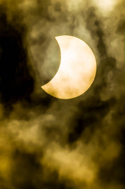 istock A yellow moon is in the sky with a dark cloud 2151705181