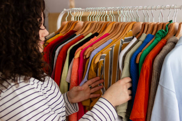 istock Woman browsing clothing at apparel store 2151706593