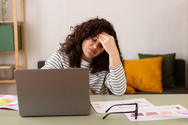 istock Stressed woman working on laptop at home 2151706645