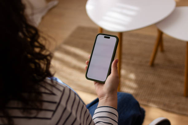 istock Woman holding smartphone with blank screen 2151706920