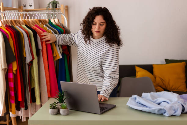 istock Young woman working from home and sorting laundry 2151706959