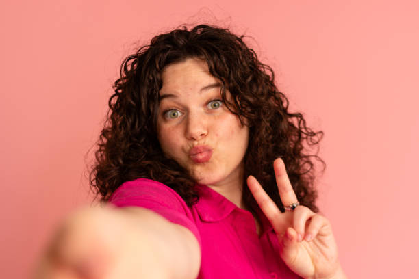 istock Playful woman taking a selfie with peace sign 2151707377
