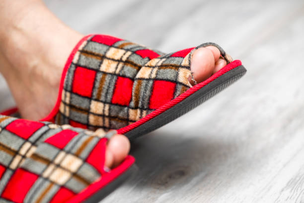 Closeup of a man's feet in fluffy slippers.c