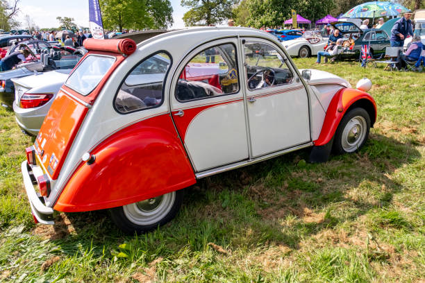 Earsham, Norfolk, UK  May 05 2024. Orange and white classic 1982 Citroen 2 CV car on public display at a local car meet