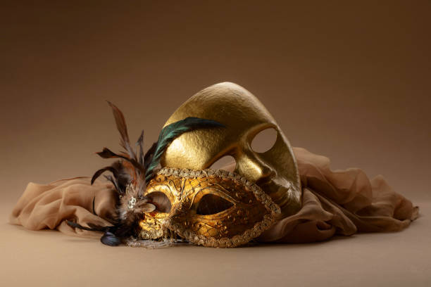 istock Golden Venetian carnival masks on a beige background. 2151710198