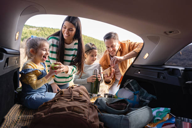 istock Parents with daughters having an snack, from the car trunk 2151710908