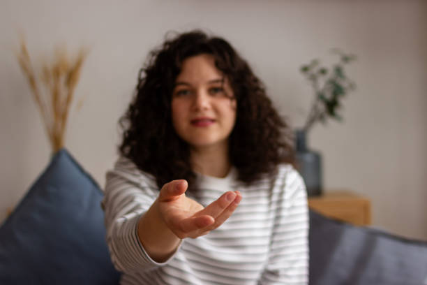 istock Young woman reaching out hand indoors 2151711990