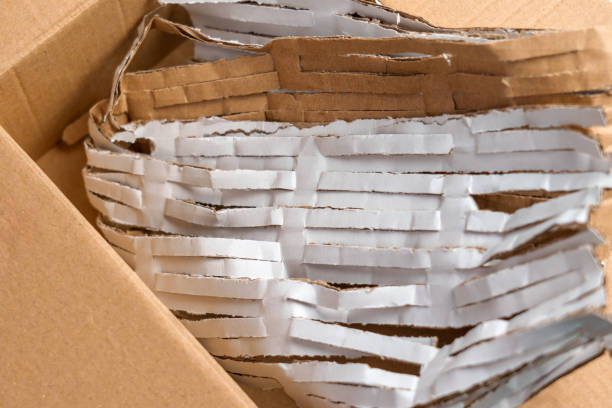 istock Cardboard box full of cut packaging paper material for parcels 2151712495