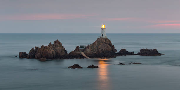 Corbiere Lighthouse off the southwest tip of Jersey on a calm evening at sunset