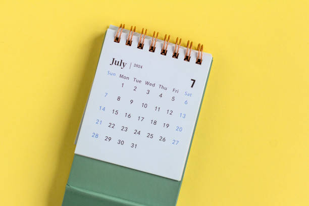 istock Desk calendar for July 2024 on a yellow background. 2151715679