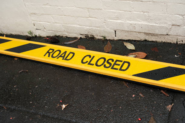 istock Road closed barrier laying on a footpath 2151719846
