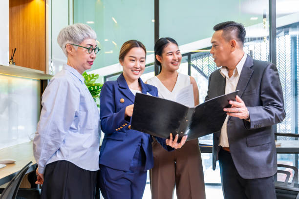istock Team of Asian people with different age group brainstorming on data and information analysis for strategy management with young leader for cooperation and business concept 2151720961