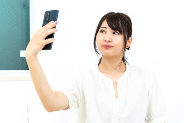 istock woman taking a selfie 2151723728