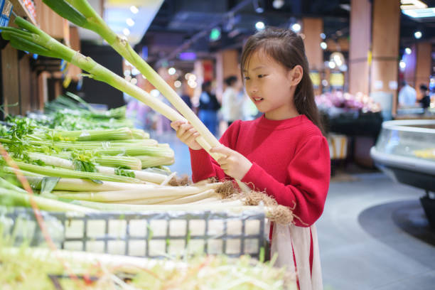 Little girl shopping for green onions