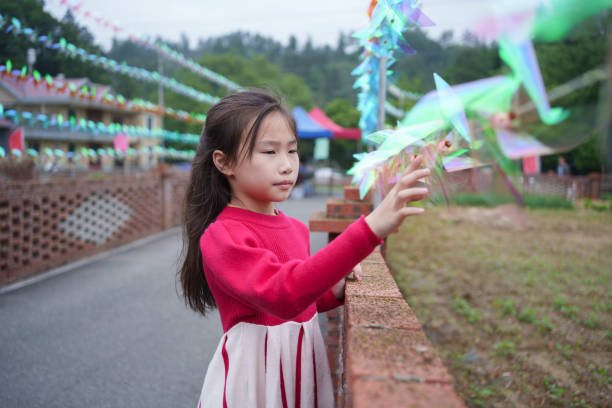 little girl playing with windmill