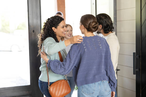istock Young adult couples smile and greet one another 2151724722