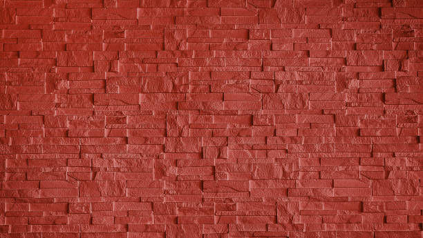 istock abstract stone cladding wall made of regular bright red bricks. abstract wall panels for decoration, background and texture. red wall made from grunge stone material for modern style decoration. 2151726369