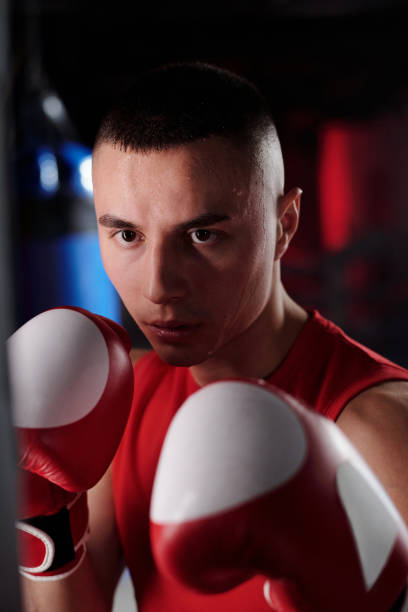 istock Boxer standing in front of punching bag 2151726526
