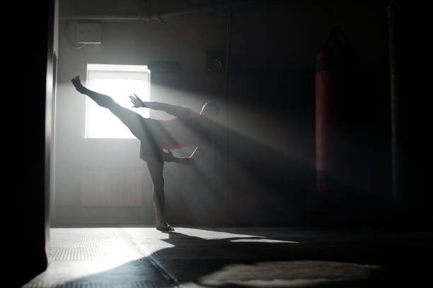 istock Backlit silhouette of young male athlete 2151726578