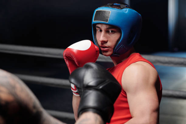 istock Guy in boxing gloves and face shield 2151726611