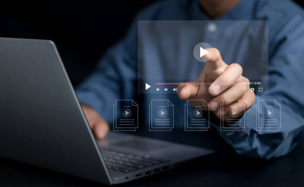 istock Man using pressing the play button to start online entertainment for an online video-on-demand streaming service over the internet that includes movies or music. 2151728381