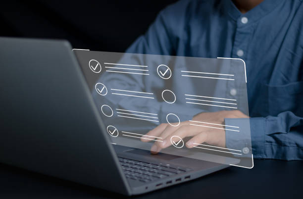 istock Businessman smart checklist and signs electronic on digital documents concept, Businessman use a pen signs on virtual screen documents with laptop on table 2151728703
