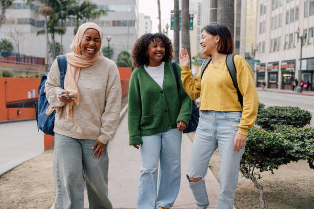 Three female students walking in downtown after school