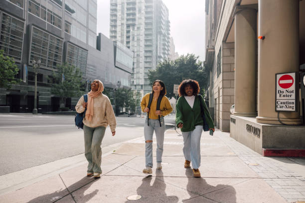 istock Three female students walking in downtown after school 2151730243