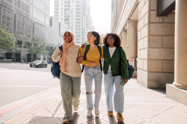 istock Three female students walking in downtown after school 2151730279
