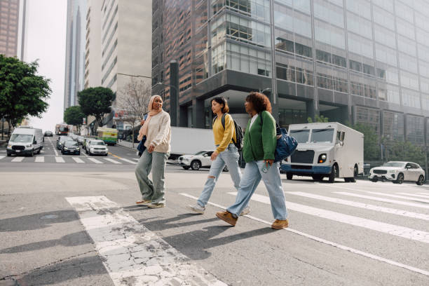 istock Three female students walking in downtown after school 2151730331
