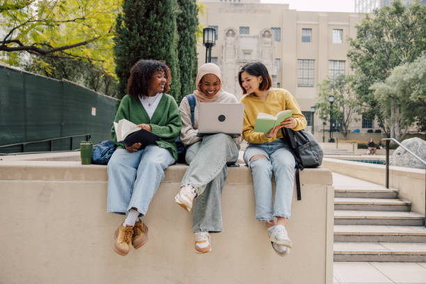 istock Three teenage student friends studying outdoors in the University campus 2151731488