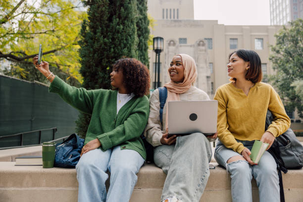 istock Happy students taking a selfie out of the University after class 2151731588