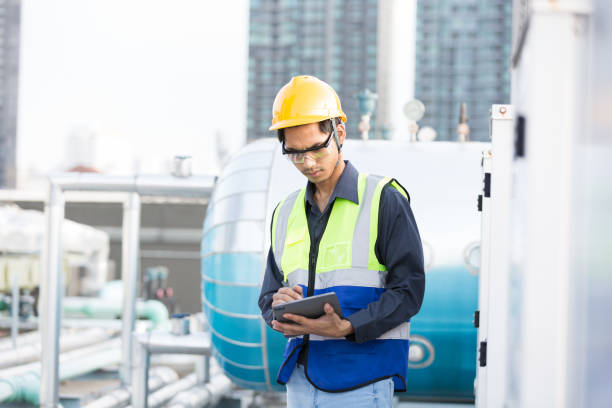 istock Male engineer worker checking, repair, maintenance operation sewer pipes area at construction site. Asian male engineer working in sewer pipes area at rooftop of building 2151731636