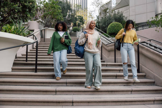 istock Three teenage students walking down University staircase 2151732149