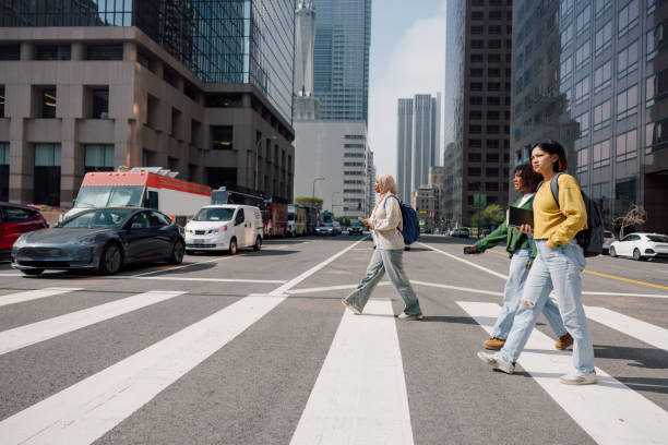 istock Three female students walking in downtown after school 2151732180