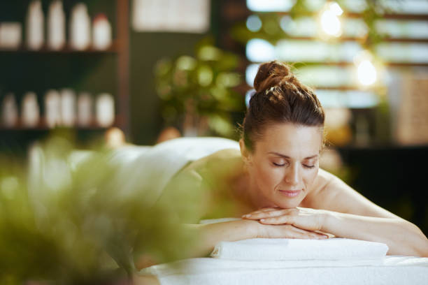 istock relaxed modern woman in spa salon laying on massage table 2151733646
