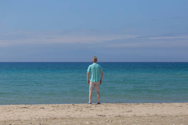 istock Man relaxing at send beach in summer 2151734783