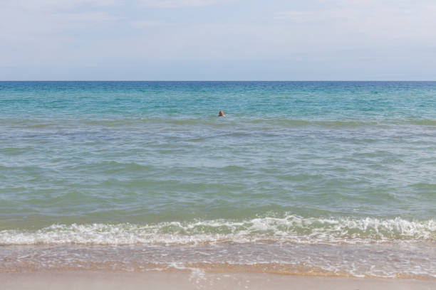 Split shot of crystal clear turquoise blue water with white sand on a clear sunny day. Photographed in Cape LeGrand, Western Australia.