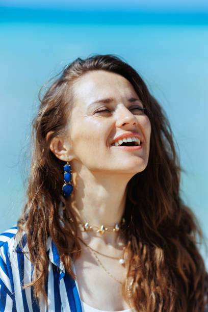 istock happy elegant woman on seacoast enjoying tranquility 2151737034