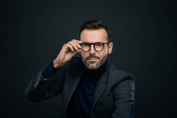 istock Studio portrait of elegant handsome man, dark background 2151737415