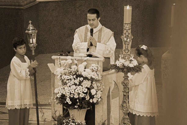 Photo of a priest and two helpers at the altar of a Catholic church located in the city of Pilar do Sul, state of São Paulo in Brazil.