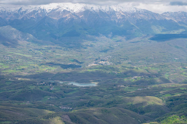 snow-capped Montefeltro mountains in the warm light of sunset against the cloudy sky