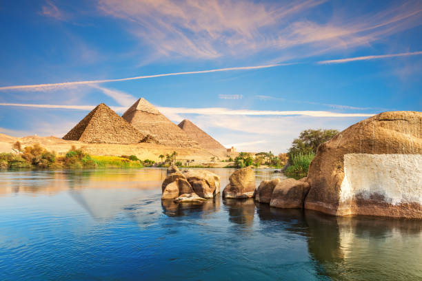 istock Sunset over the Nile river with ancient rocks on the way to pyramids, Aswan, Egypt 2151747881