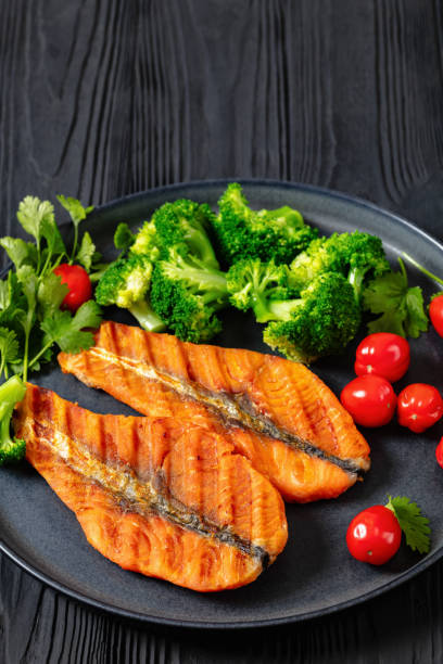 istock grilled salmon steaks with broccoli and tomatoes 2151751305