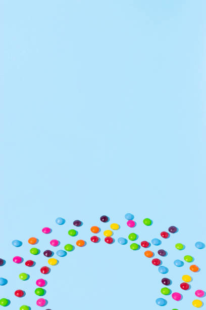 istock Sweet multicolored candies on a bright blue background. Minimal summer concept. 2151751646