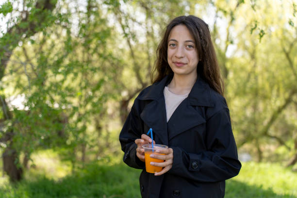 A girl drinking orange juice.