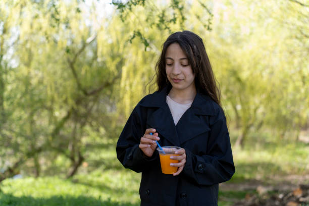 istock A girl drinking orange juice. 2151755248
